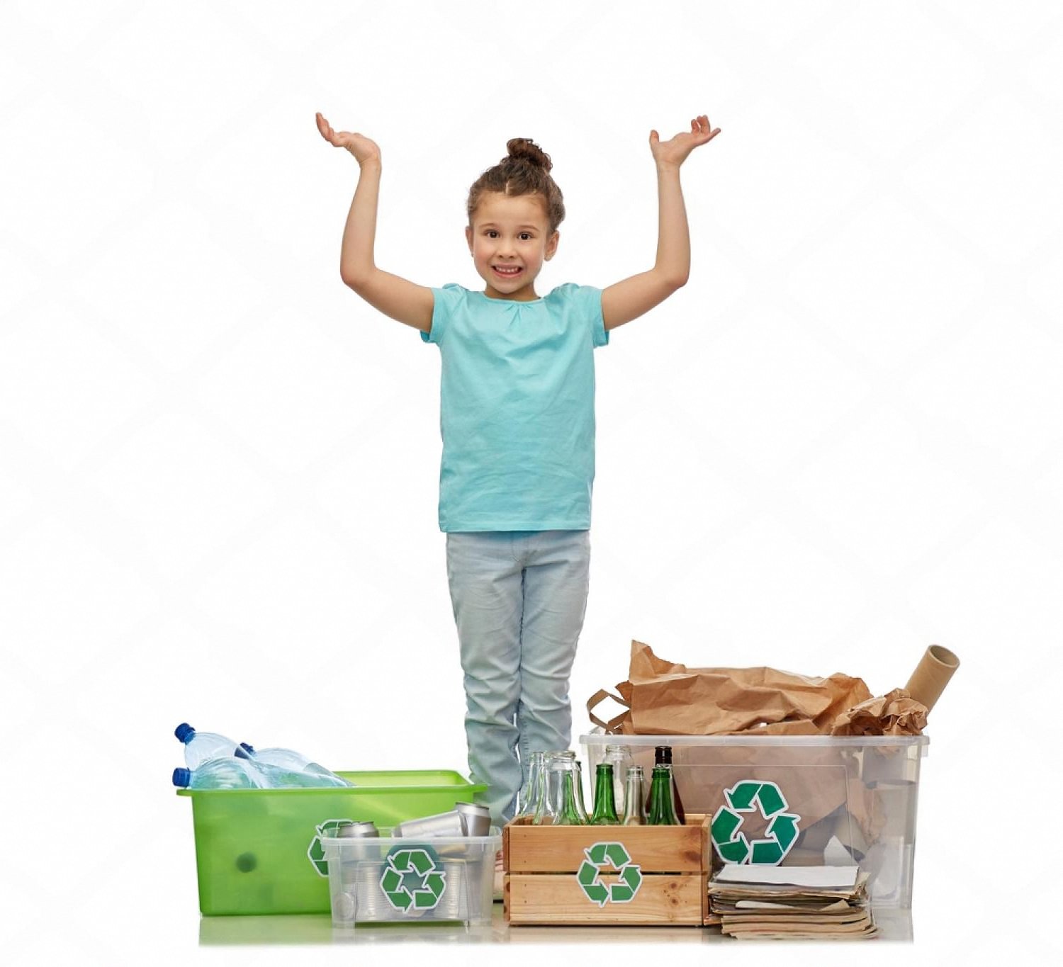 Smiling schoolgirl standing between bins of sorted glass, plastic and paper for classroom recycling
